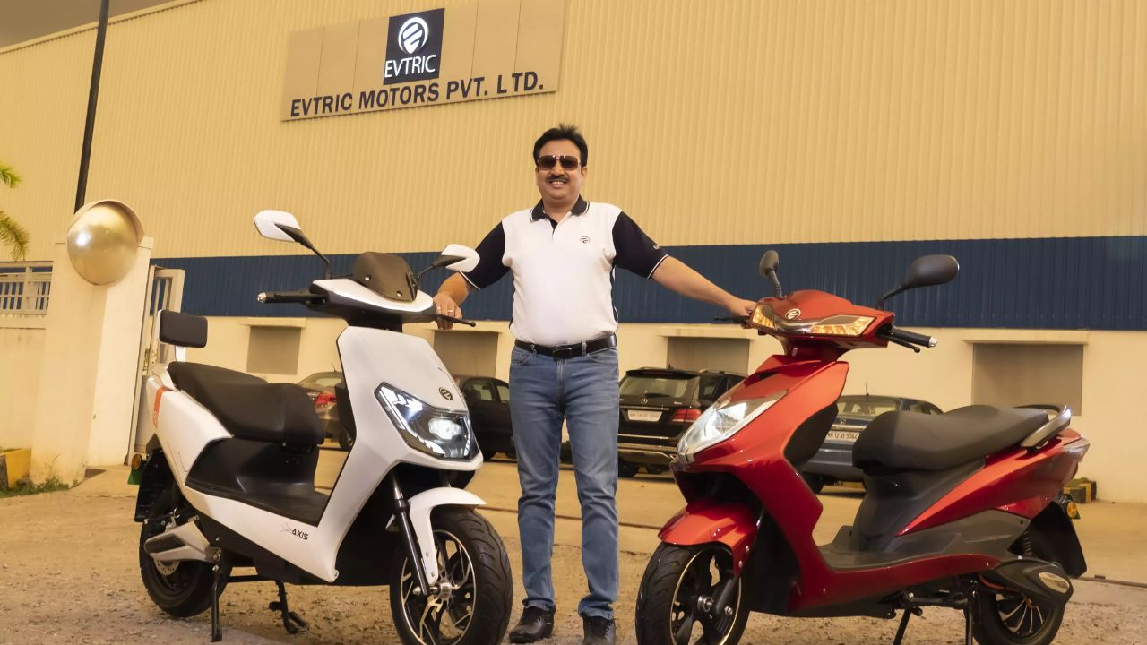 A image of Two Electric scooter of Evtric Ride with a man holding both the scooter