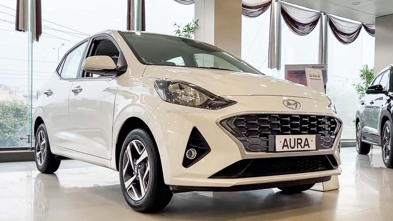 A image of White colour Hyundai Aura which is palaced in car showroom