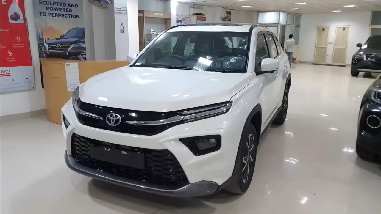 A image of white colour Toyota Hyryder Mini Fortuner which is palaced in car showroom